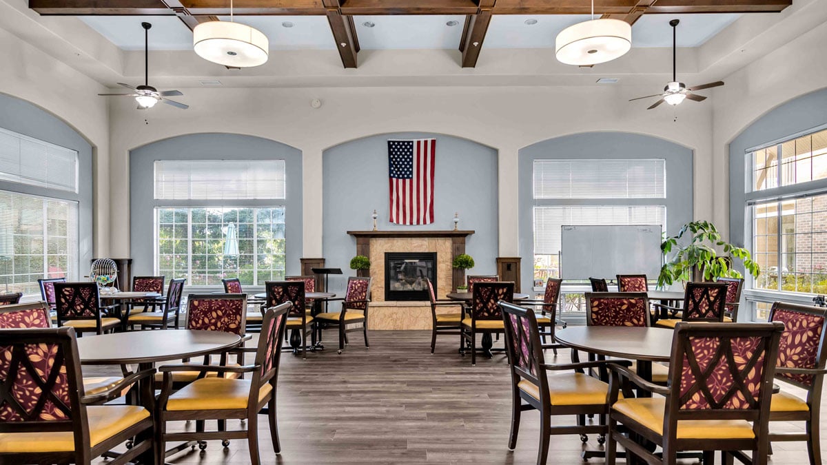 A cozy fireplace lounge at Colonial Gardens